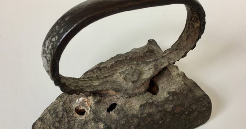 Sad irons, kettles and other non-cookware - An antique "sad iron", so named because of its heavy weight and hot handle.